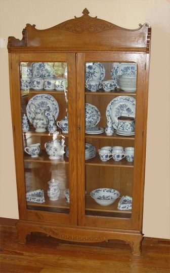 Appraisal: LATE VICTORIAN GOLDEN OAK BOOKCASE CHINA CABINET Relief carved backsplash