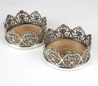 Appraisal: A pair of English silver plate wine coasters Late th