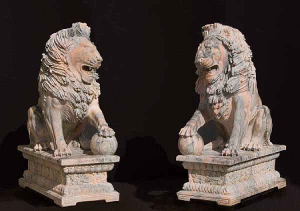 Appraisal: A pair of variegated gray and salmon marble garden lions