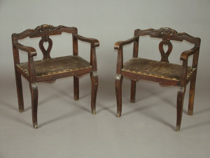 Appraisal: A pair of stained beech side chairs with pierced carved