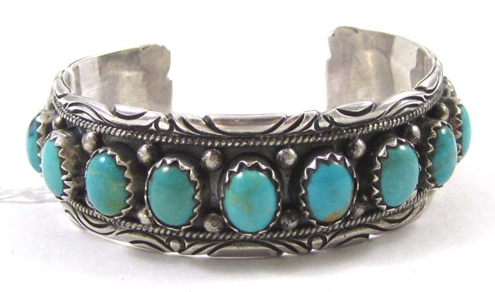 Appraisal: ZUNI INDIAN STERLING SILVER BANGLE set with thirteen oval well