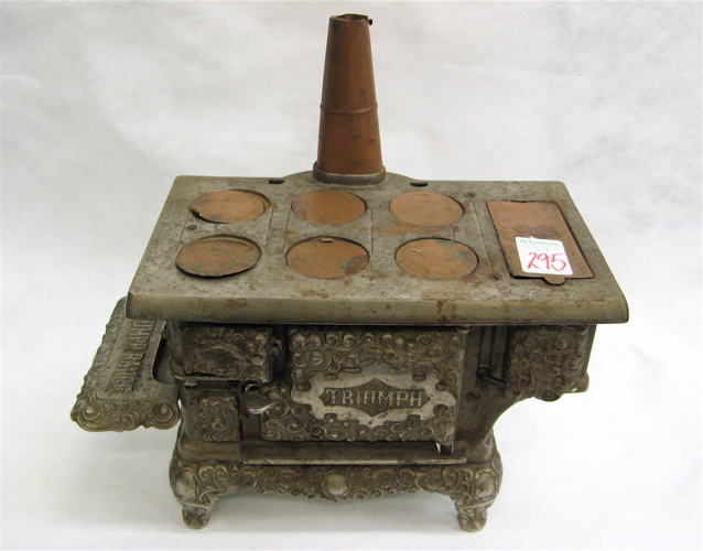 Appraisal: TRIUMPH CAST IRON COPPER MINIATURE COOK STOVE th century in