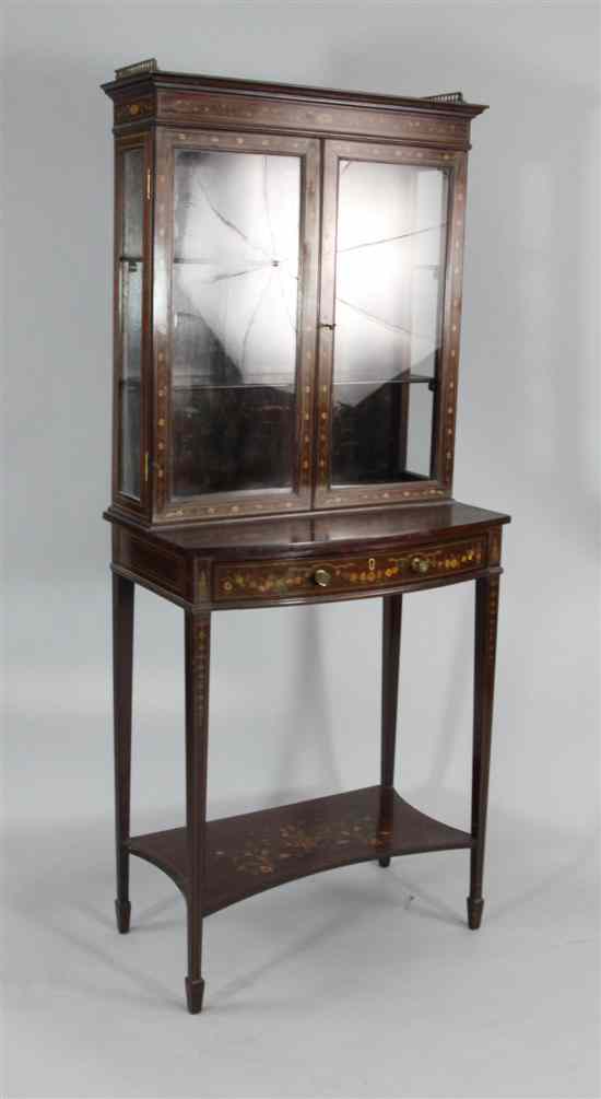 Appraisal: An Edwardian inlaid mahogany bowfront display cabinet with two doors