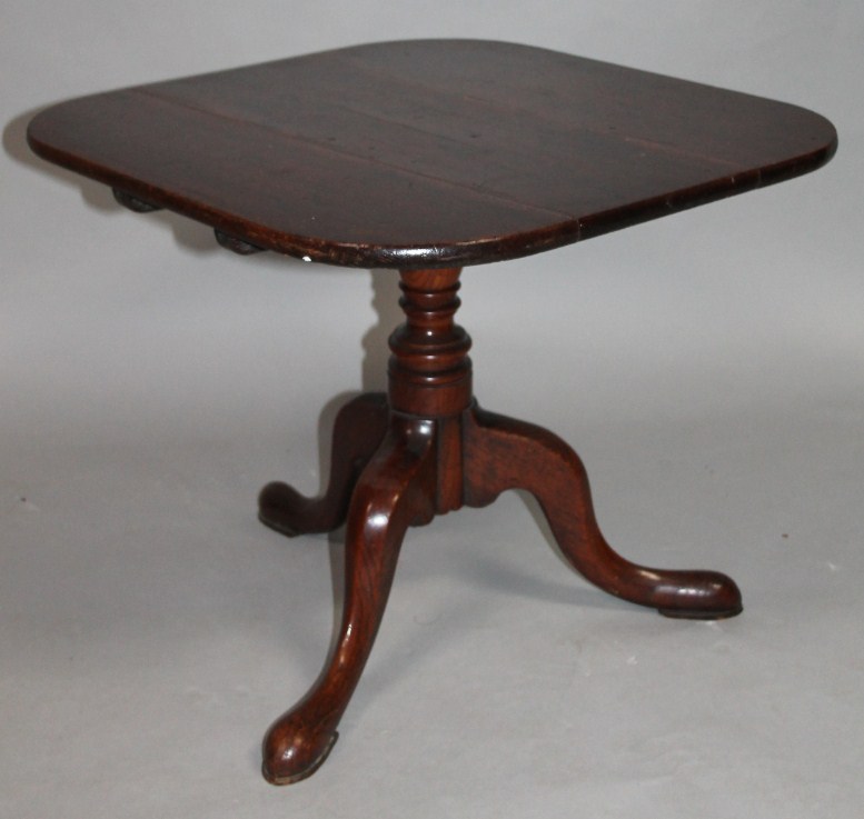 Appraisal: A low occasional table the shaped plank top raised on