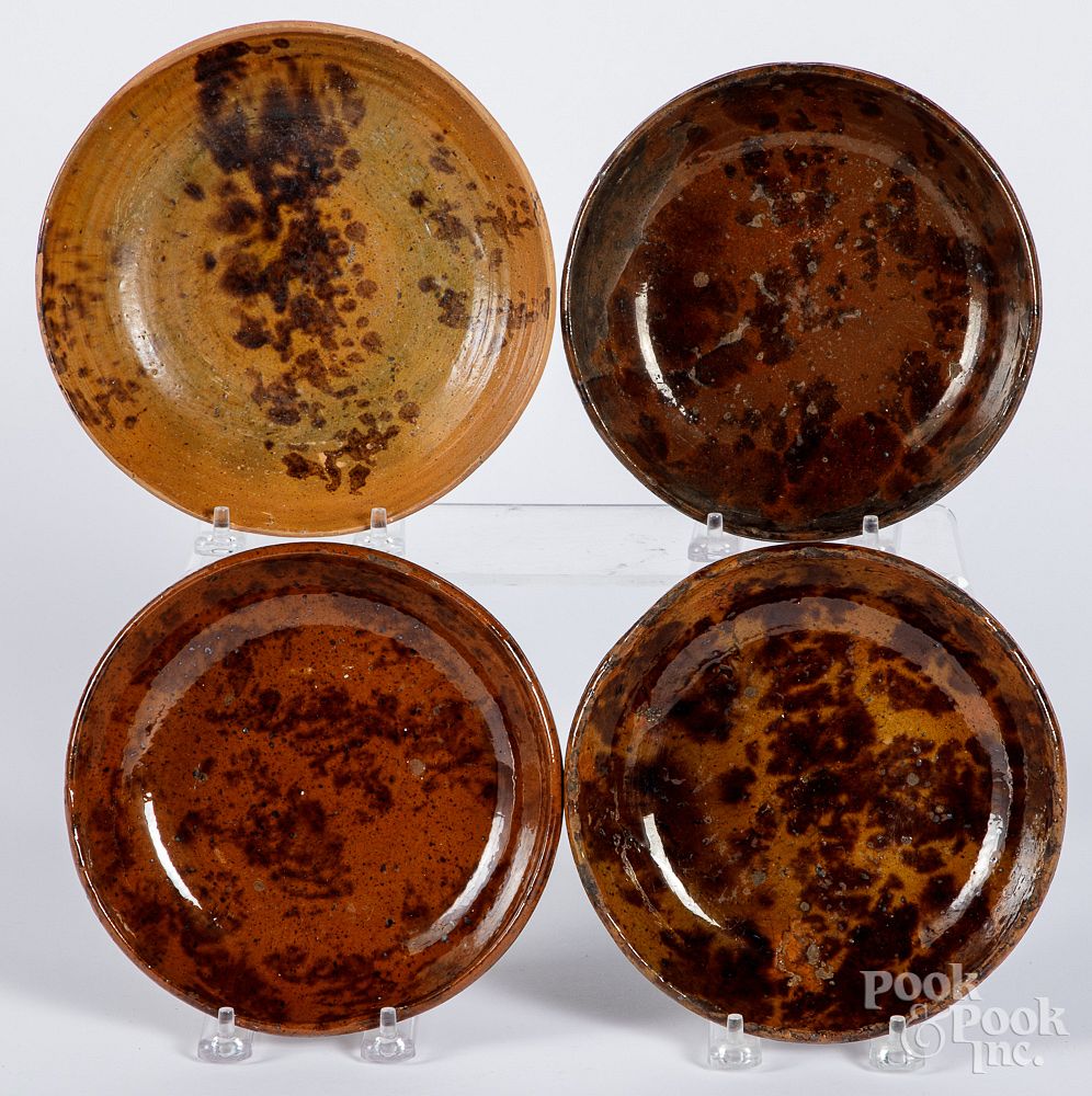 Appraisal: Four Pennsylvania redware shallow bowls Four Pennsylvania redware shallow bowls