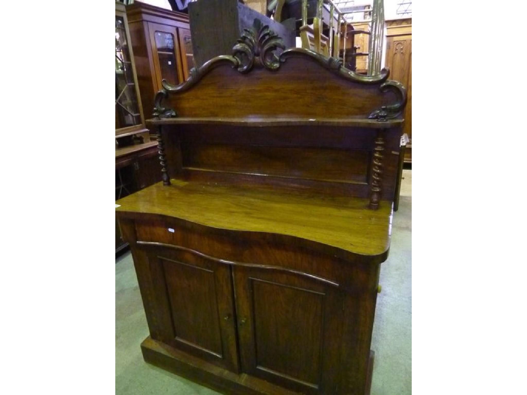 Appraisal: A Victorian walnut chiffonier the raised back with shaped outline