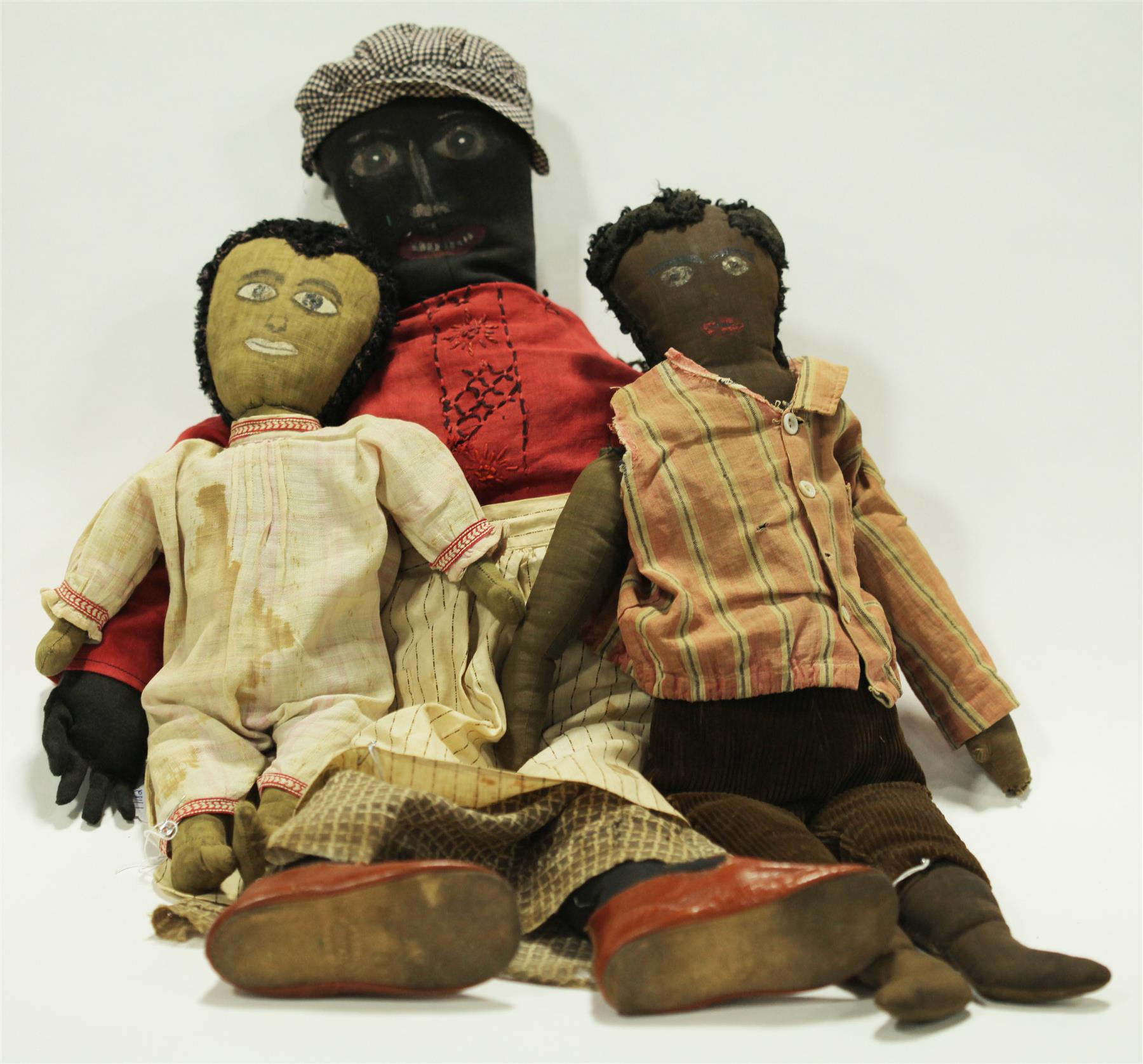 Appraisal: THREE BLACK CLOTH DOLLS WITH PAINTED FACES American late th-early