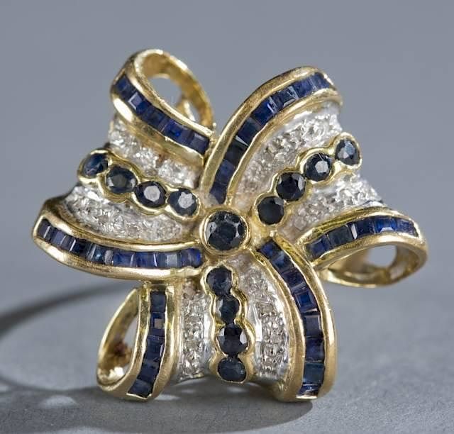 Appraisal: Three ribbon bow ring with diamonds and sapphires A three