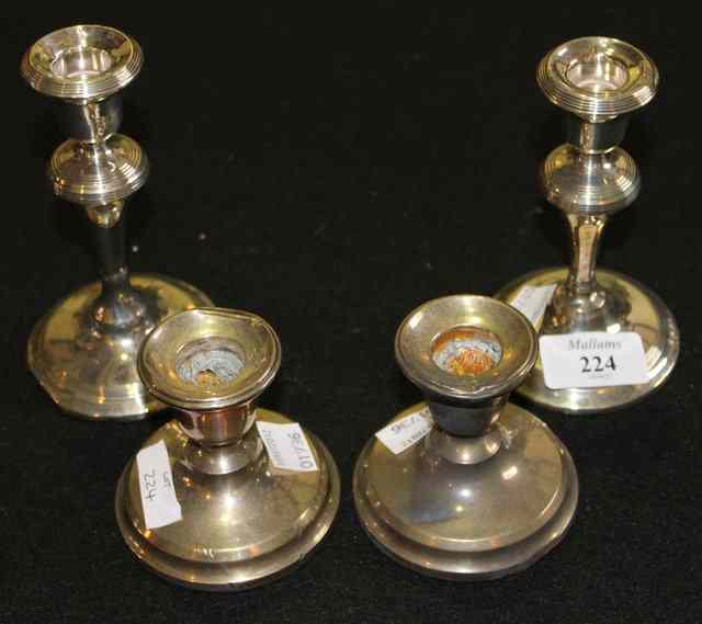 Appraisal: TWO PAIRS OF SILVER CANDLESTICKS one pair with reeded borders