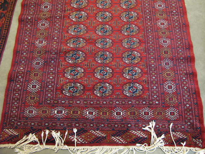 Appraisal: RED BOKHARA AREA RUG overall geometric gol design hand knotted