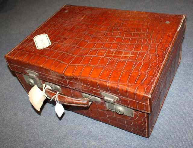 Appraisal: A CROCODILE SKIN TRAVELLING SUITCASE with fitted silk interior wide