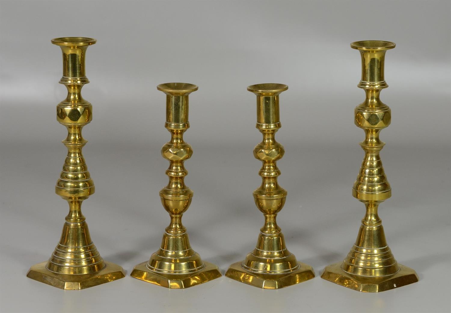 Appraisal: Pairs of English Brass Push-Up Candlesticks larger pair marked England