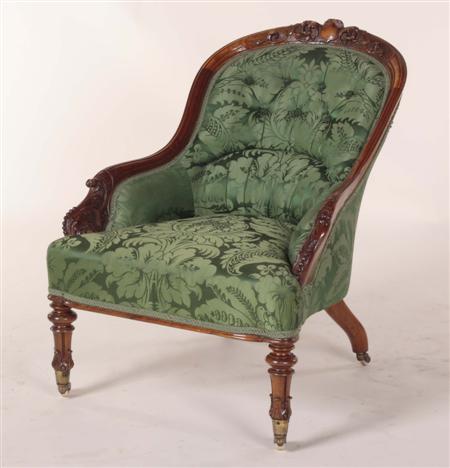 Appraisal: A Victorian walnut button back armchair the foliate carved frame