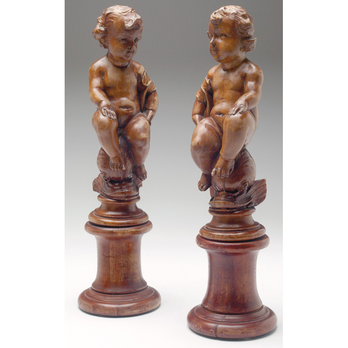 Appraisal: Ricardo Merino wood sculptures pair hand carved cherubs each perched