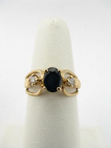 Appraisal: K yellow gold ring with oval cut sapphire center stone