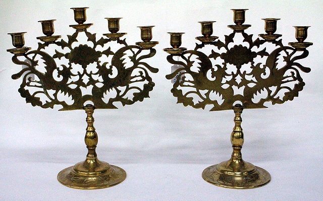 Appraisal: A PAIR OF EASTERN BRASS FIVE BRANCH CANDELABRA each with