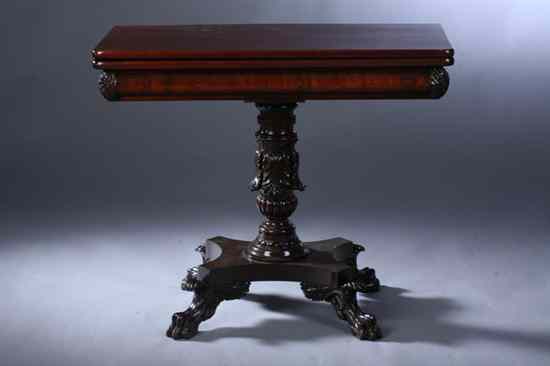 Appraisal: AMERICAN EMPIRE FLAME MAHOGANY CARD TABLE Swivel-top above carved acanthus