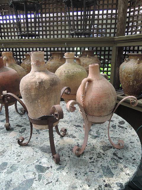 Appraisal: A COLLECTION OF THREE SPANISH EARTHENWARE AMPHORAE ON IRON STANDSvarious