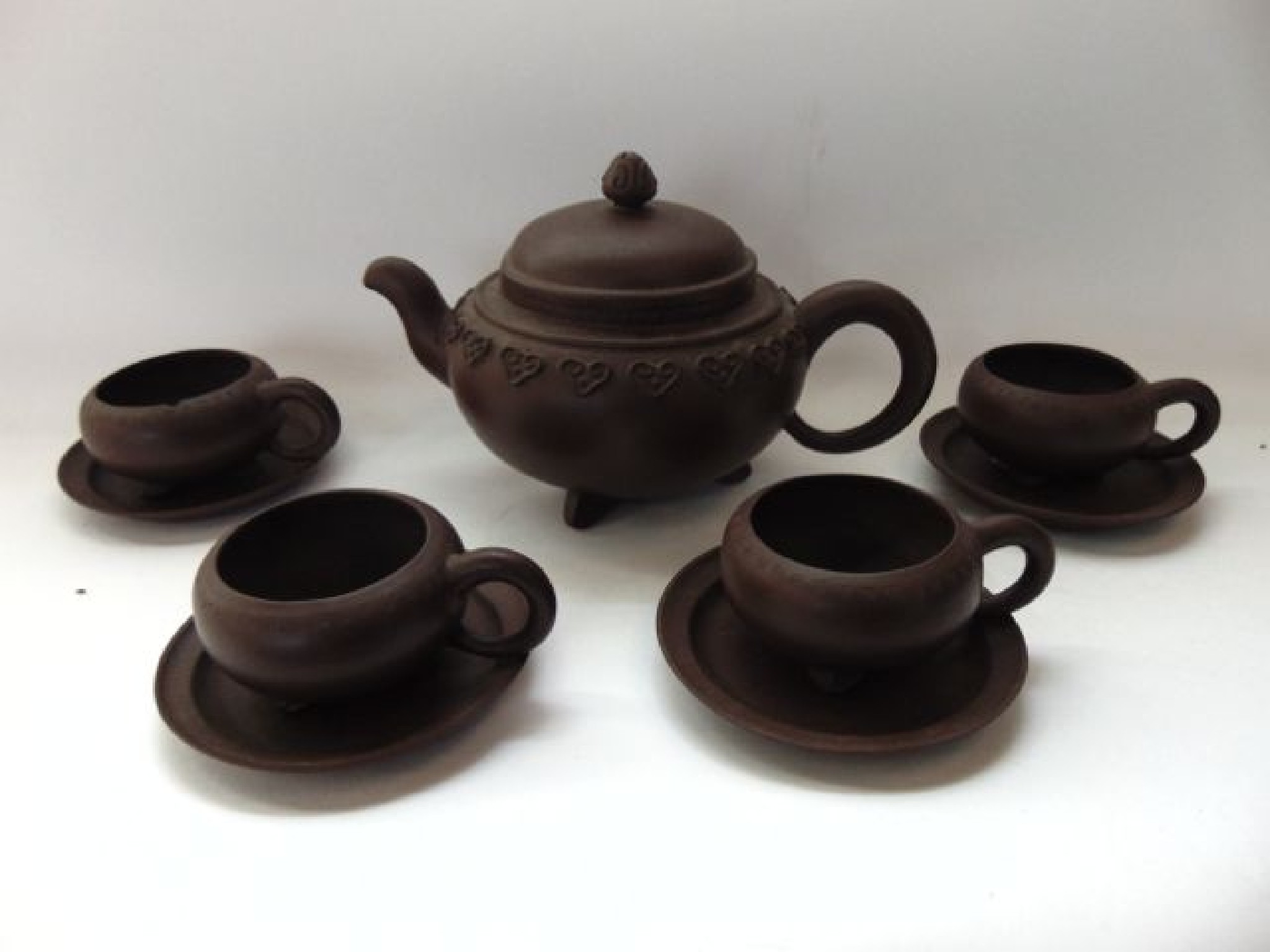 Appraisal: A collection of oriental dark red terracotta tea wares comprising