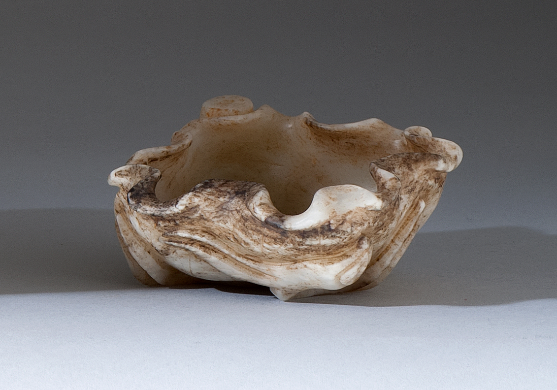 Appraisal: WHITE AND BROWN JADE WRITER'S COUPE Late th CenturyIn the