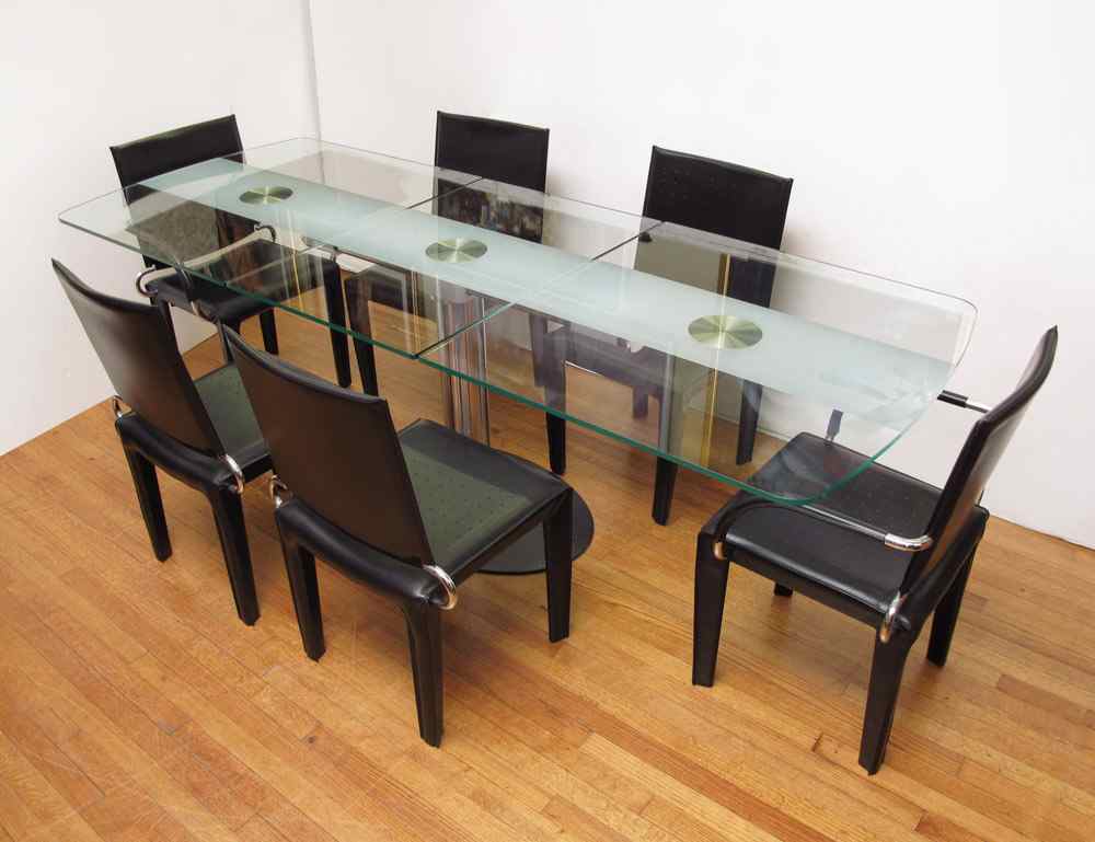 Appraisal: ITALIAN GLASS TOP EXTENSION DINING TABLE AND ARPER LEATHER CHAIRS