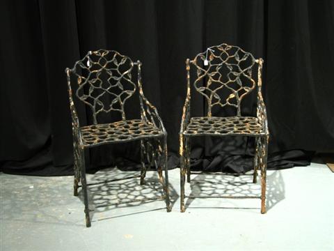 Appraisal: PAIR OF SMALL WROUGHT IRON GARDEN CHAIRS Formed from intertwined