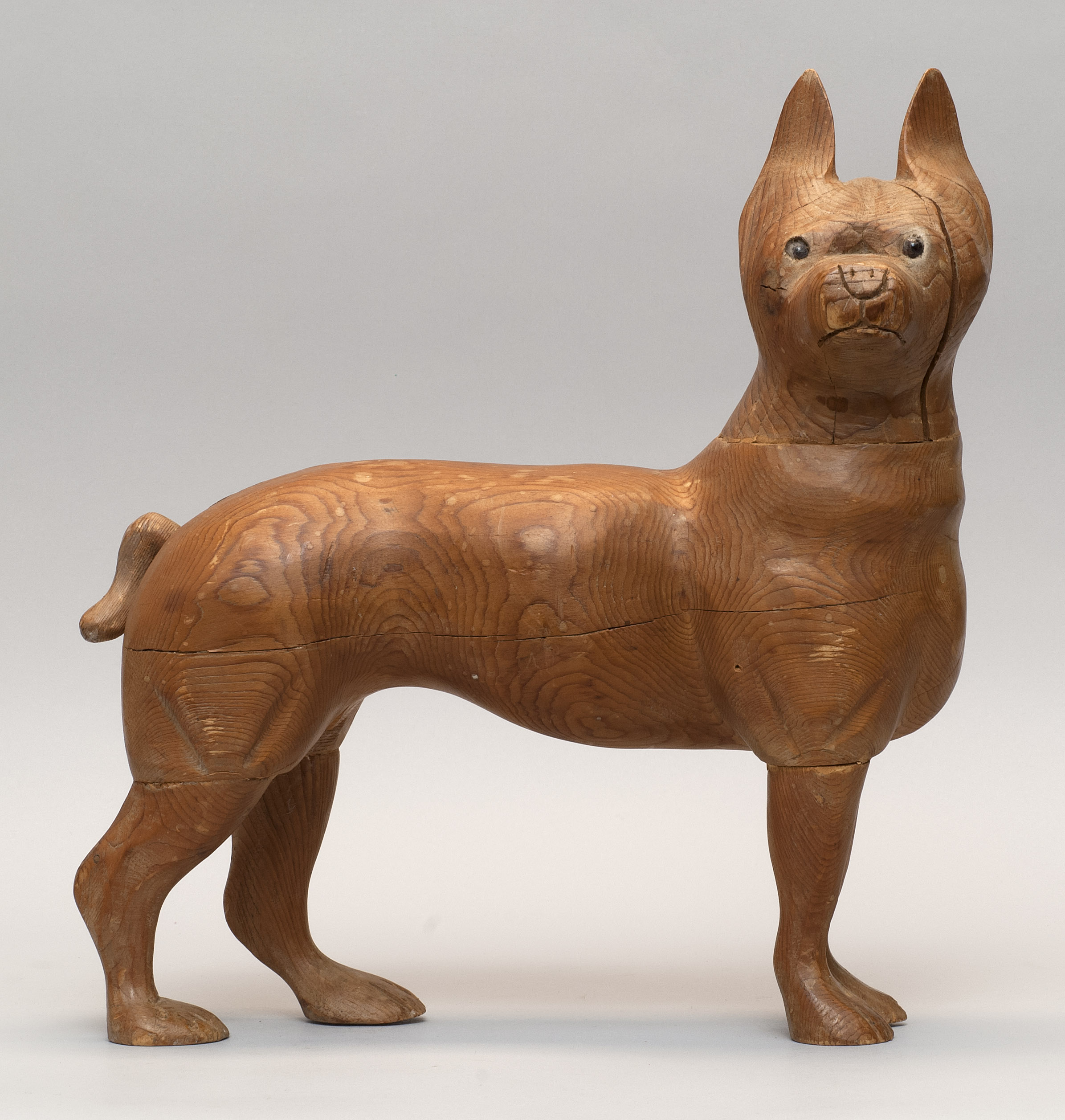 Appraisal: CARVED ELMWOOD DOG With glass eyes Height Length ConditionAge cracks