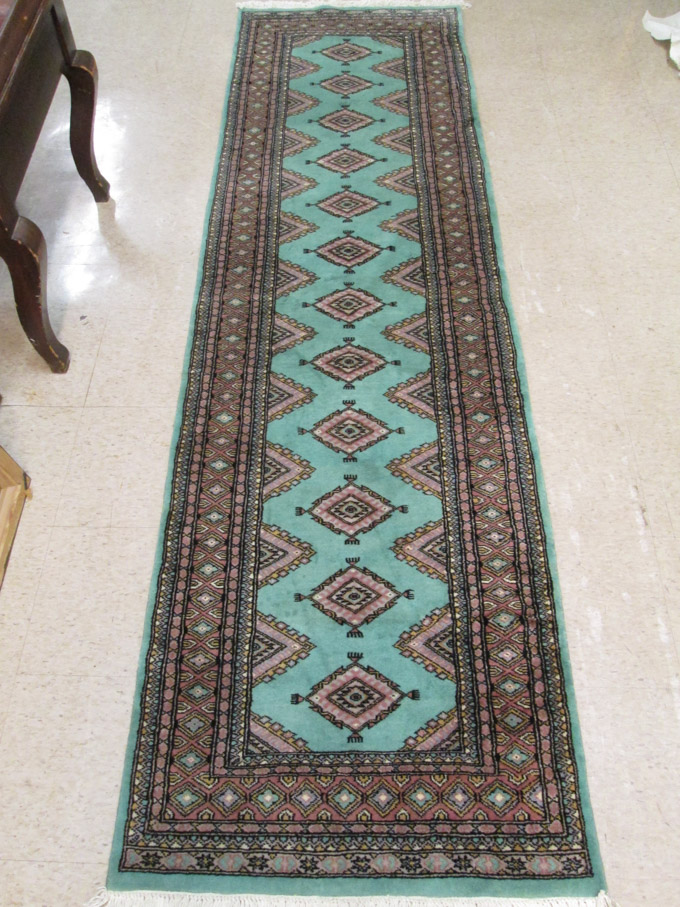 Appraisal: HAND KNOTTED BOKHARA RUNNER India or Pakistan featuring a teal