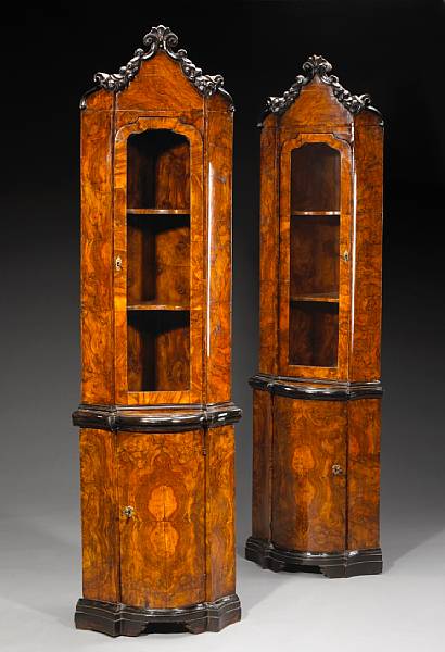 Appraisal: A pair of Italian Rococo parcel ebonized walnut corner cabinets