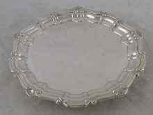 Appraisal: A silver salver with shell and scroll rim on claw