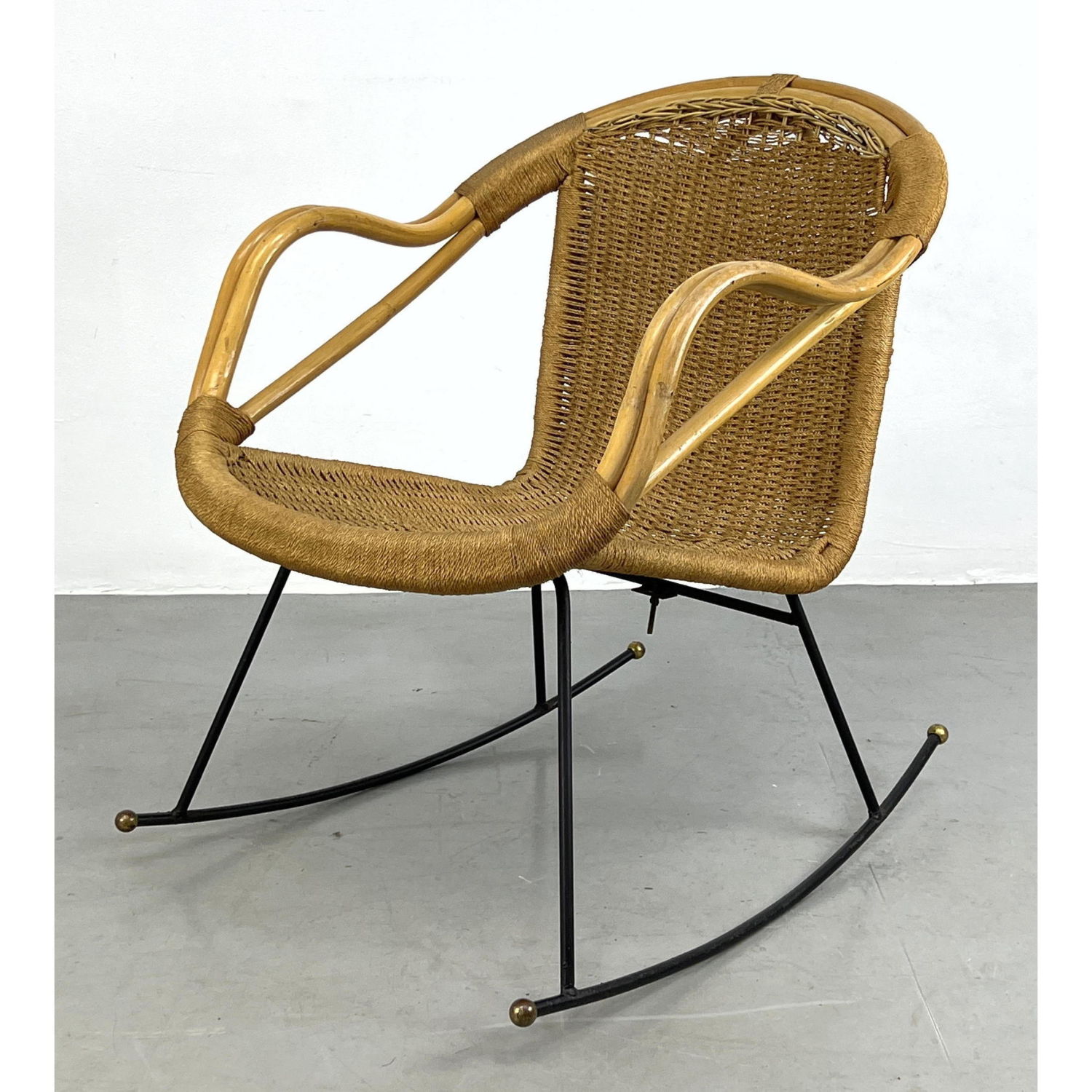 Appraisal: Rattan and Cord Mid Century Modern Rocking Chair Iron base