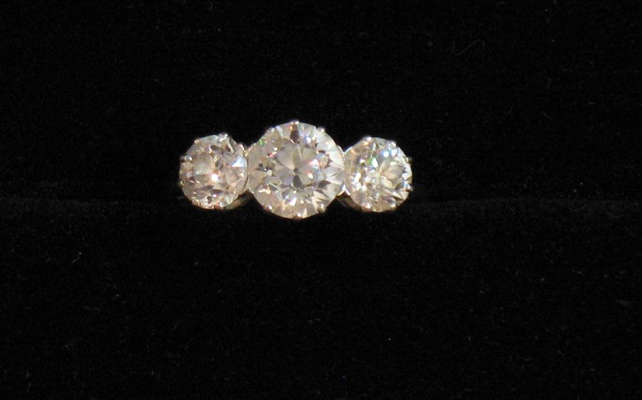 Appraisal: A THREE STONE DIAMOND RING the large central old-cut diamond