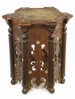 Appraisal: A Middle Eastern carved hardwood hexagonal table with panels of