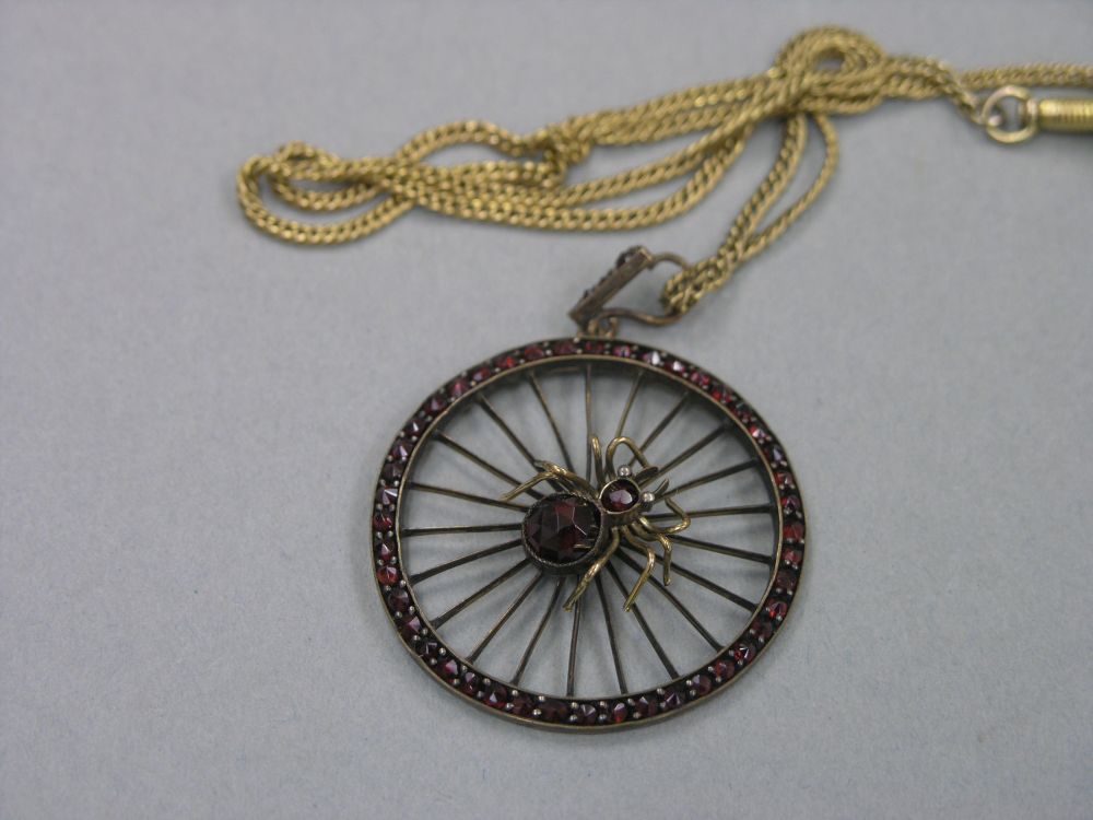 Appraisal: A late Victorian garnet spider brooch on chain circular pendant