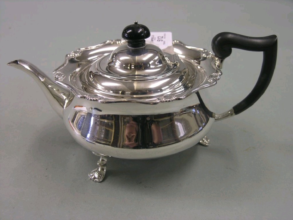 Appraisal: A silver tea pot circular shape the rim cast with