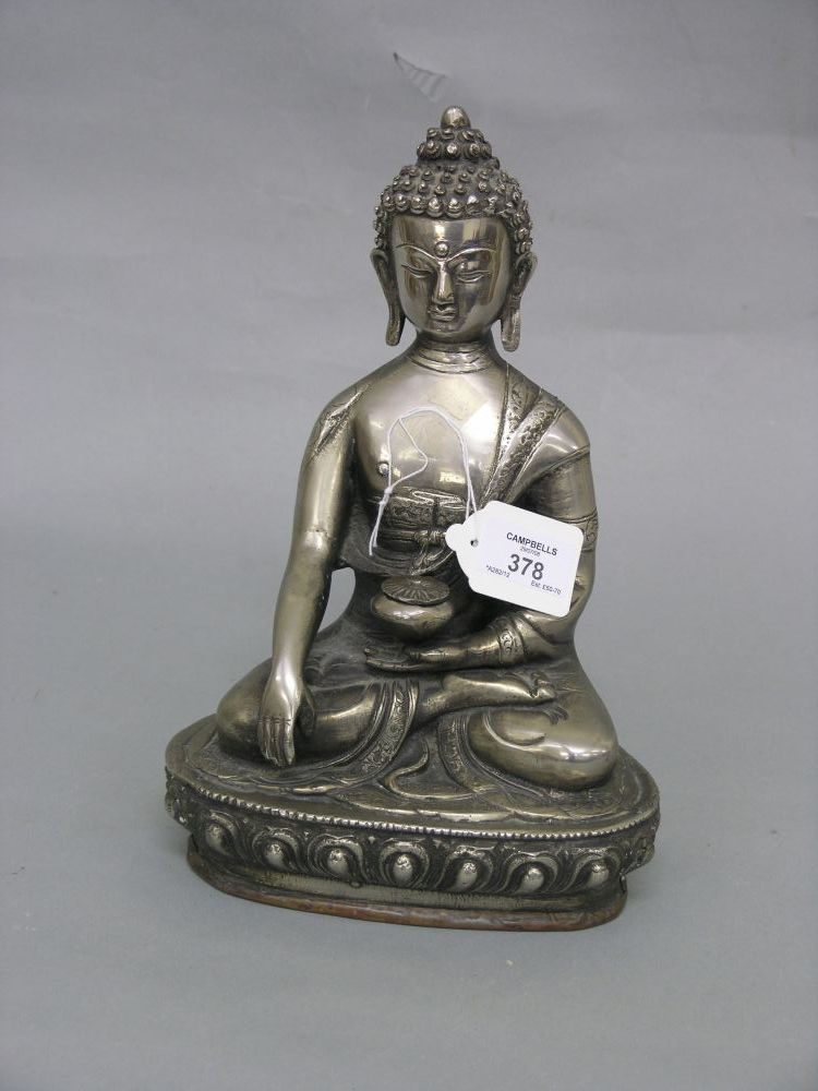 Appraisal: A th century Tibetan silvered metal Buddha seated pose holding