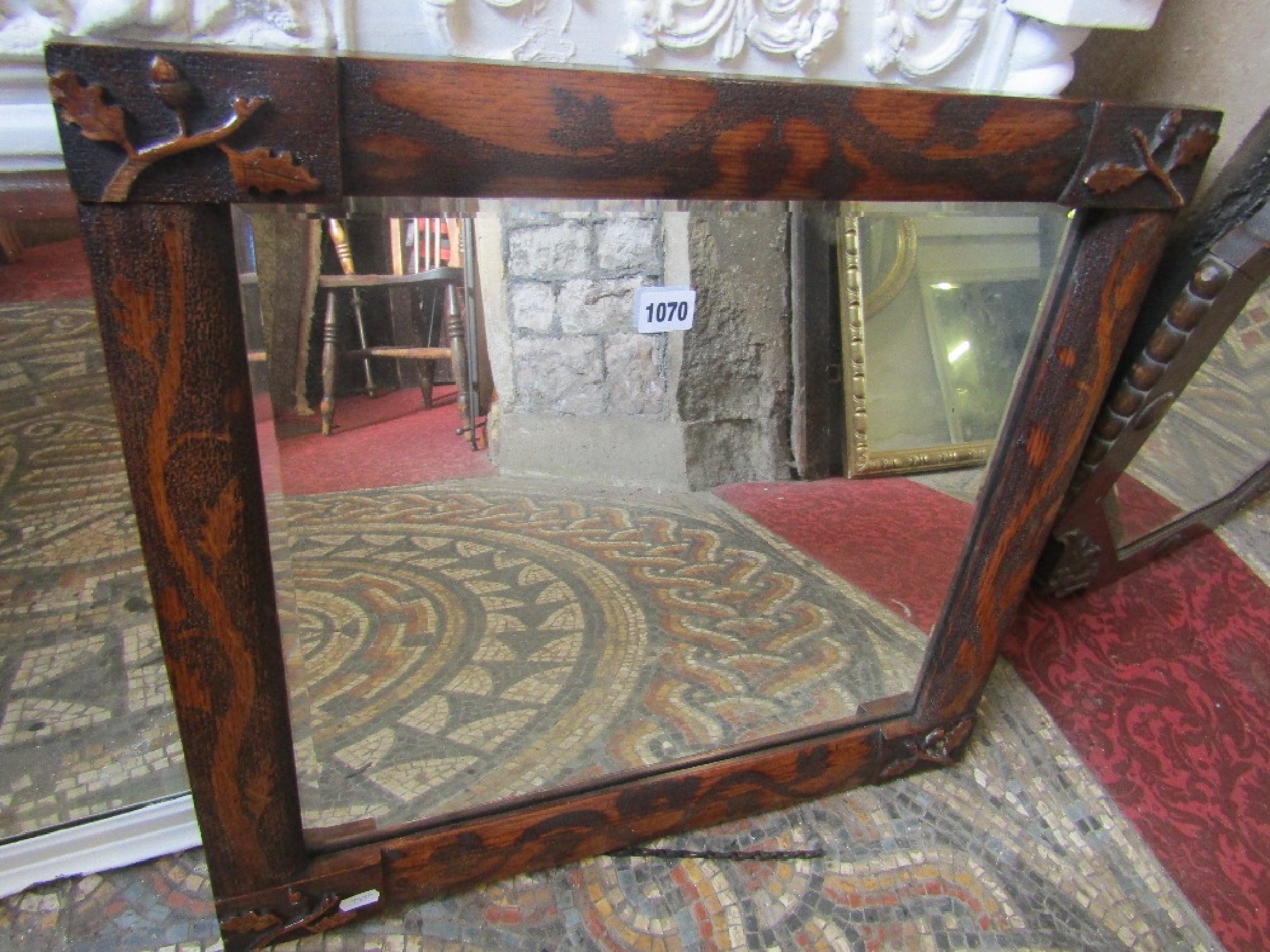 Appraisal: An oak framed wall mirror of rectangular form with bevelled