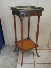 Appraisal: A bronze mounted satinwood stand with undertier and gallery to