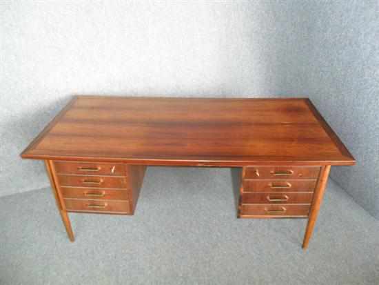 Appraisal: A DANISH ROSEWOOD DESK with eight drawers to the front