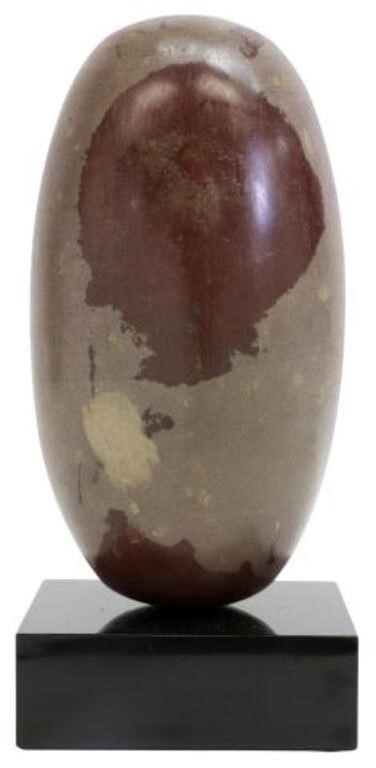 Appraisal: Shiva Lingam stone India on black marble base fossil approx