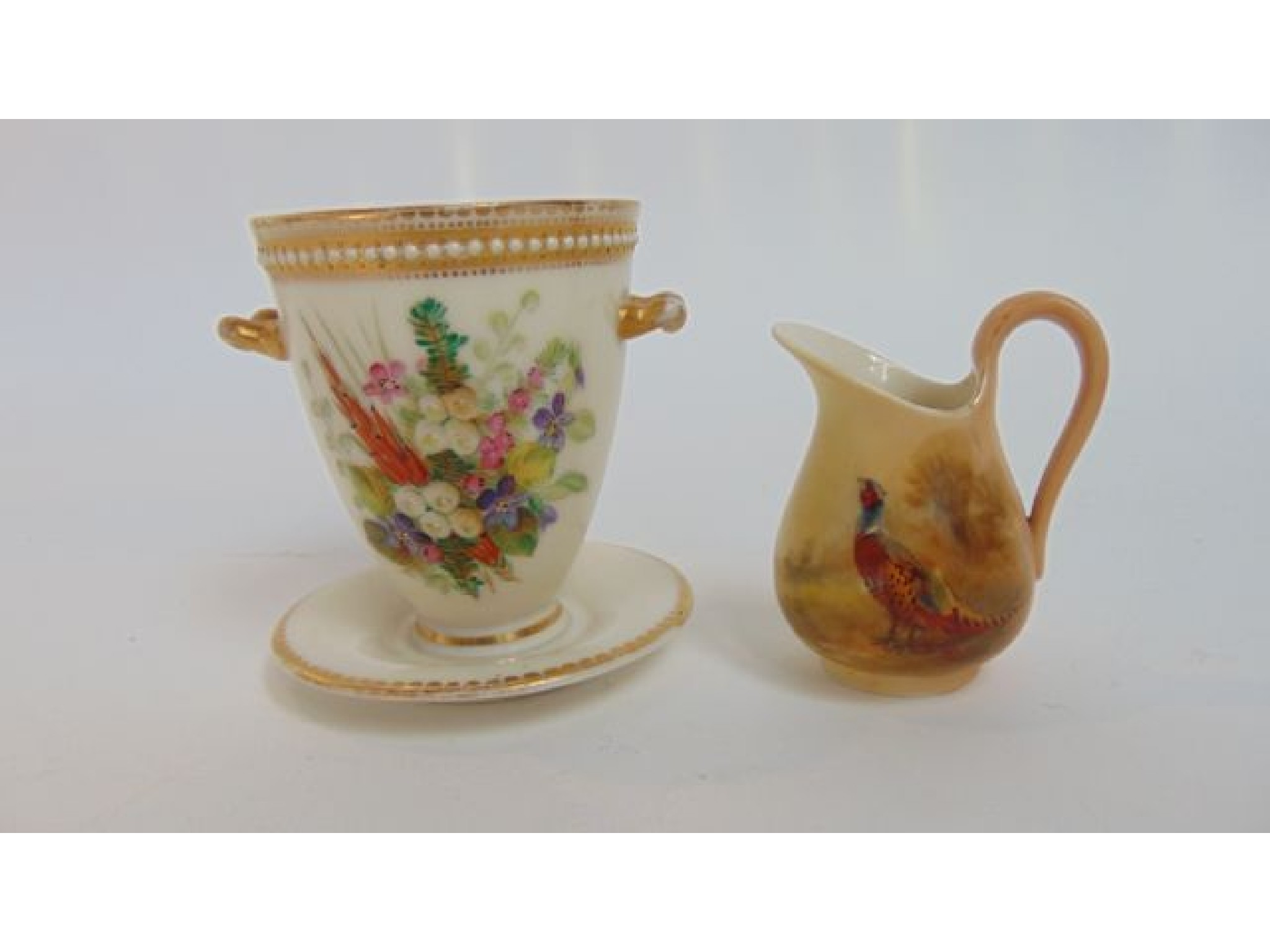 Appraisal: A Royal Worcester ivory ground two handled vase with integral