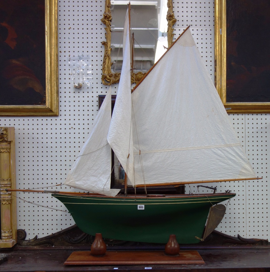 Appraisal: A wooden model boat fully rigged with green painted hull