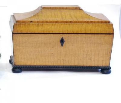 Appraisal: A REGENCY SATINWOOD TEA CADDY of sarcophagus form with ebony