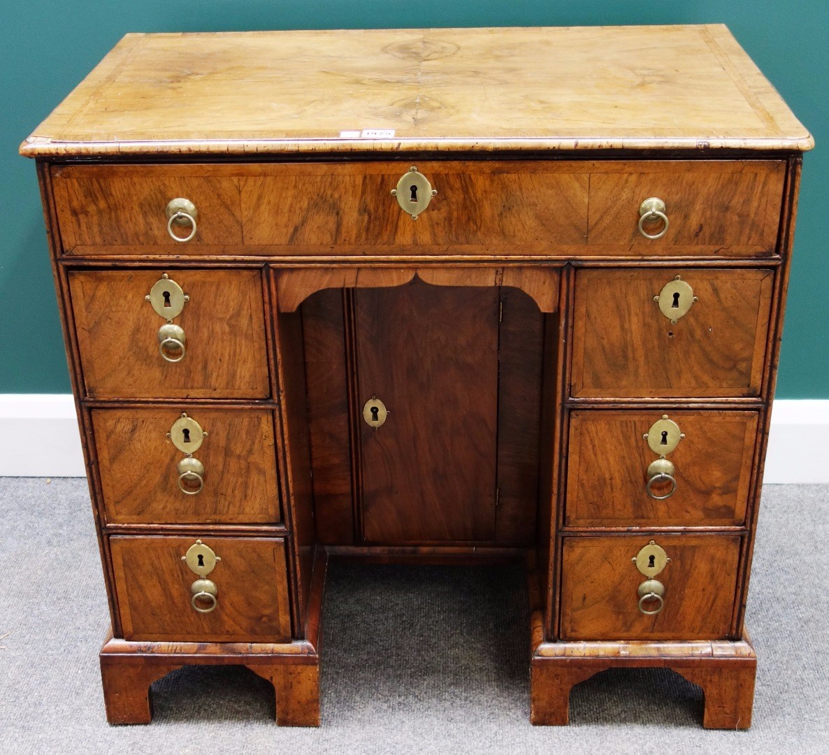 Appraisal: An early th century feather banded walnut kneehole writing desk