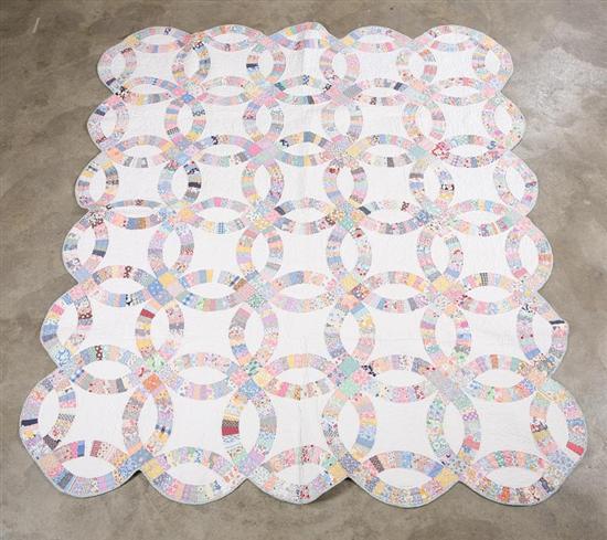 Appraisal: DOUBLE WEDDING RING QUILT - Printed fabrics on white Scalloped