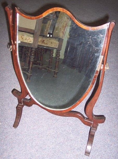 Appraisal: A th Century mahogany framed shield shaped mirror on a