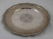 Appraisal: A Persian silver standard plate with applied floral stiffened rim