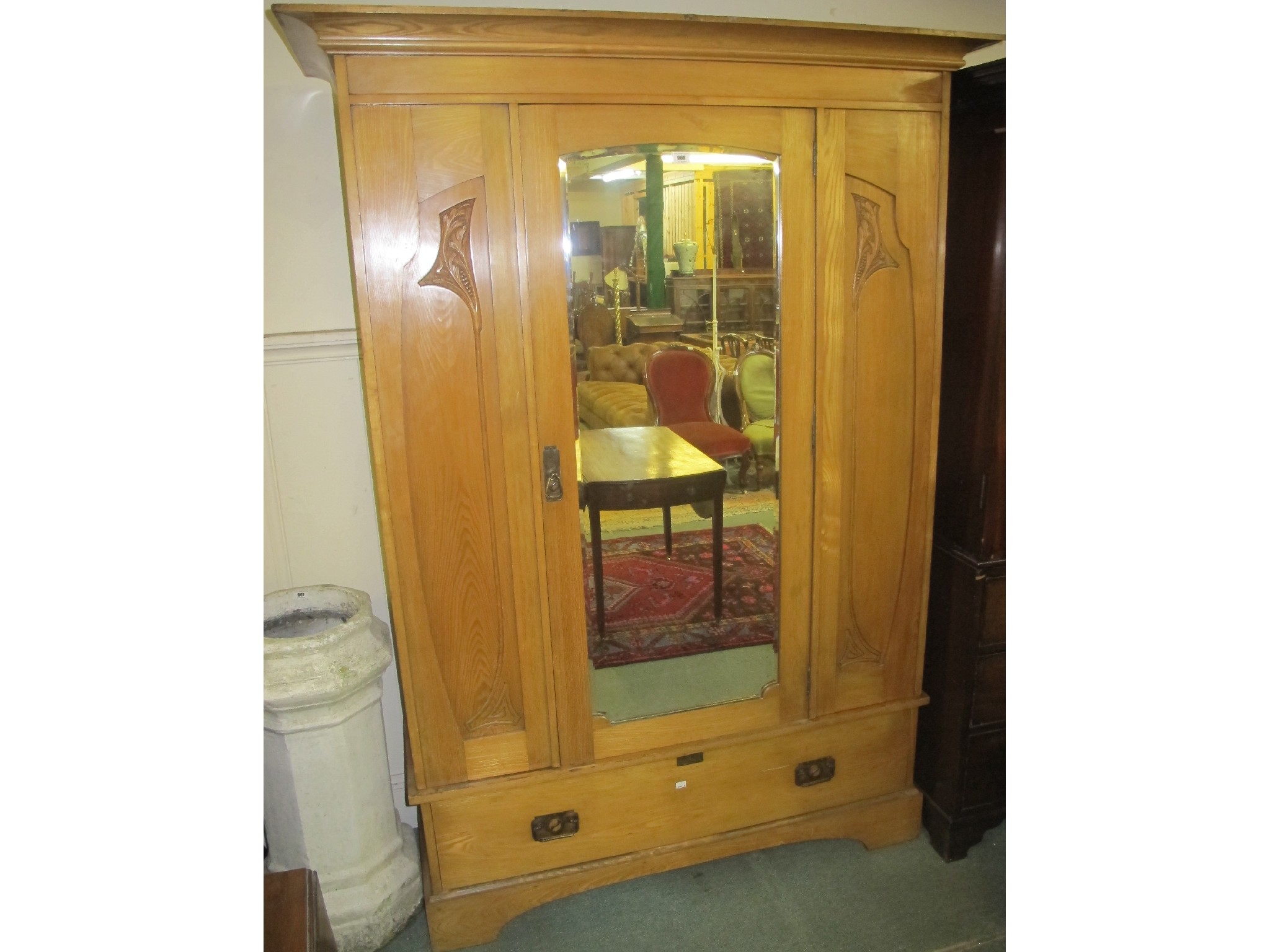 Appraisal: A pine mirror door wardrobe with floral carvings