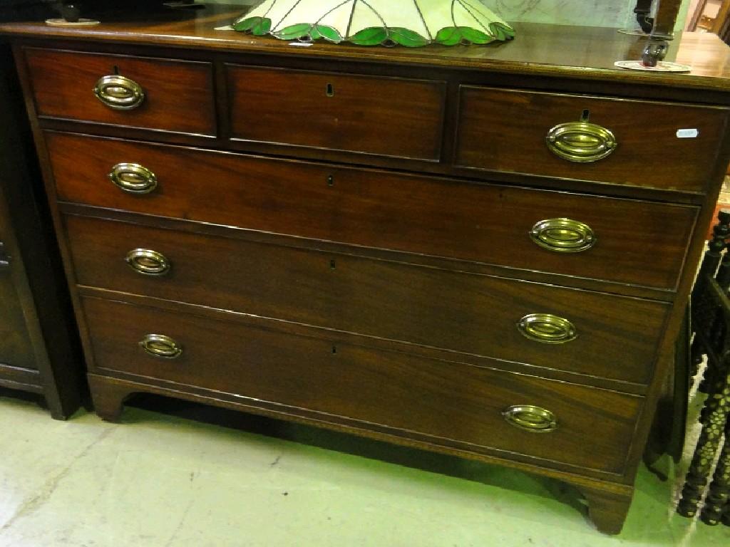 Appraisal: A broad Georgian mahogany chest fitted with an arrangement of