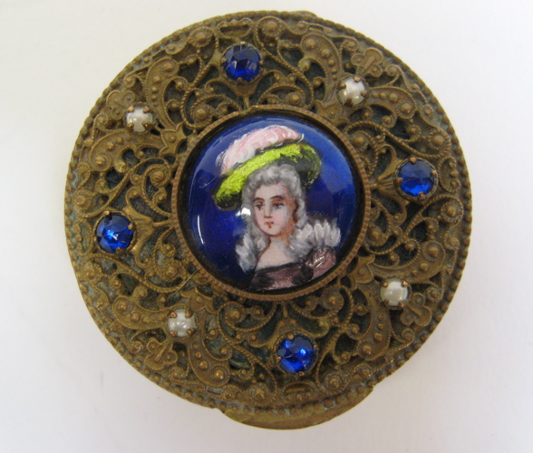 Appraisal: FRENCH GILT METAL ENAMELED PORTRAIT COMPACT having a round enameled